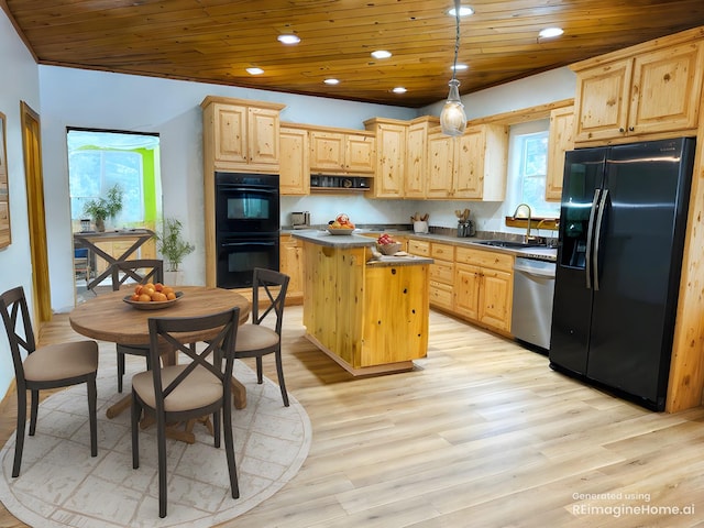 kitchen featuring sink, black appliances, a kitchen island, decorative light fixtures, and light brown cabinets