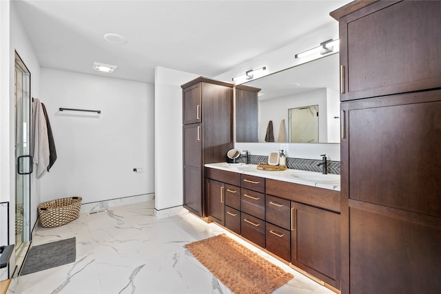 bathroom with vanity and a shower with shower door