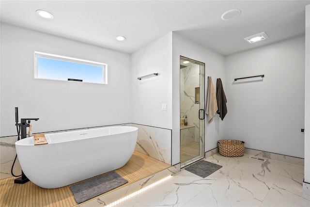 bathroom featuring separate shower and tub