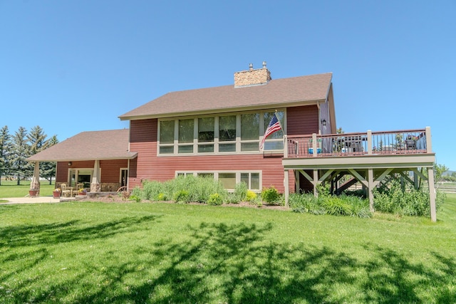 6809 N Montana Ave, Helena, MT 59602 - rear view of house featuring a lawn, a wooden deck, a chimney, and a shingled roof