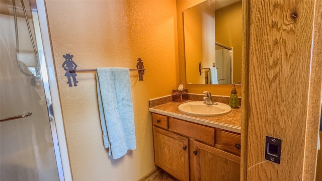 6809 N Montana Ave, Helena, MT 59602 - bathroom featuring vanity, a shower stall, and a textured wall