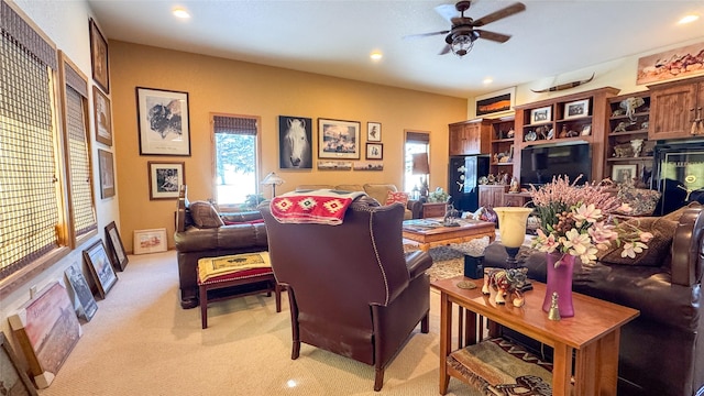 living room featuring light colored carpet and ceiling fan