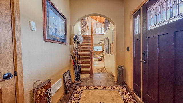 6809 N Montana Ave, Helena, MT 59602 - entryway with arched walkways, stairs, and tile patterned floors
