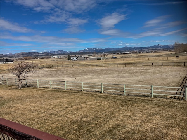 view of yard with a mountain view and a rural view