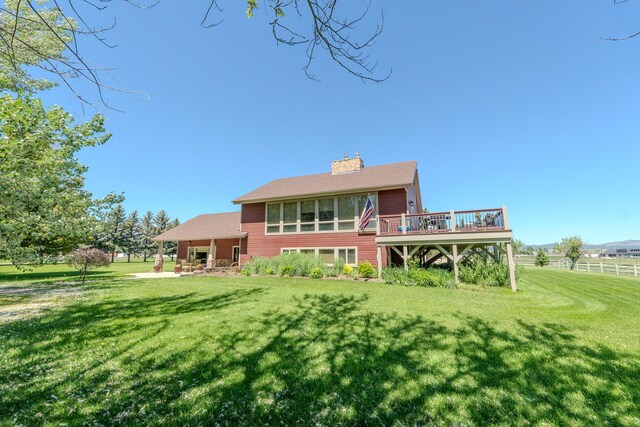 6809 N Montana Ave, Helena, MT 59602 - back of house with a lawn, a chimney, and a wooden deck