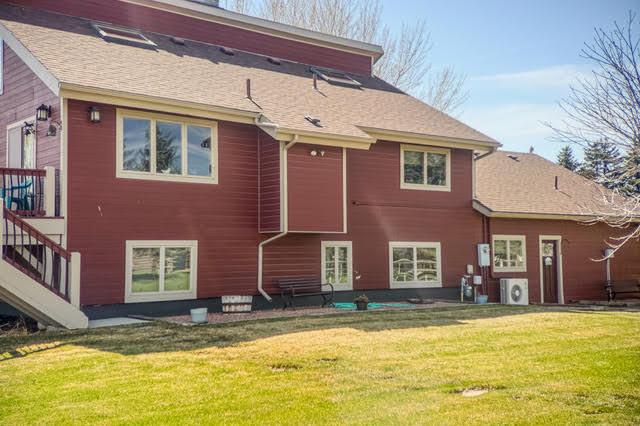 6809 N Montana Ave, Helena, MT 59602 - back of house featuring a yard and stairs