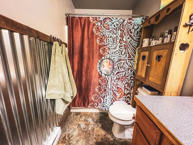 bathroom with baseboard heating, vanity, and toilet