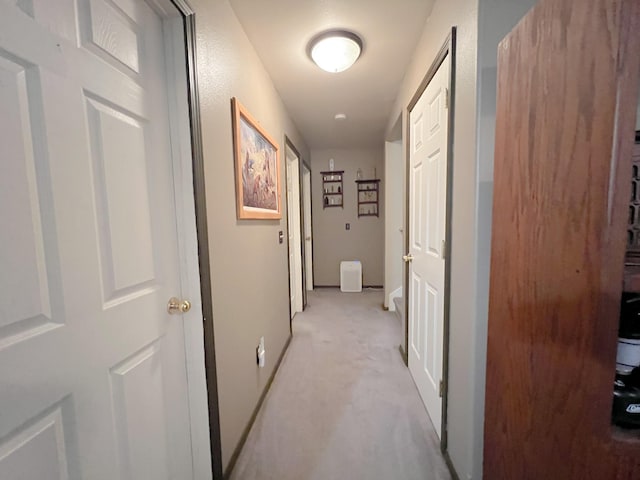 hallway featuring light carpet