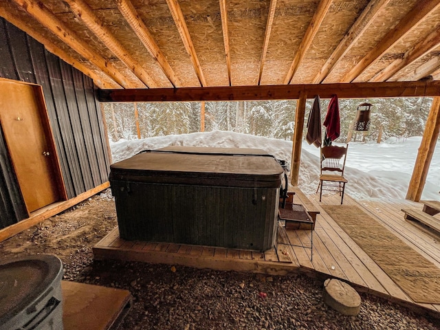 snow covered deck with a hot tub