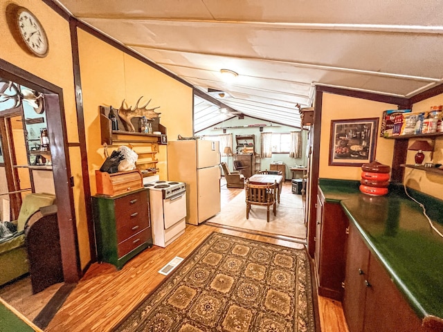 interior space featuring light wood-type flooring and vaulted ceiling with beams