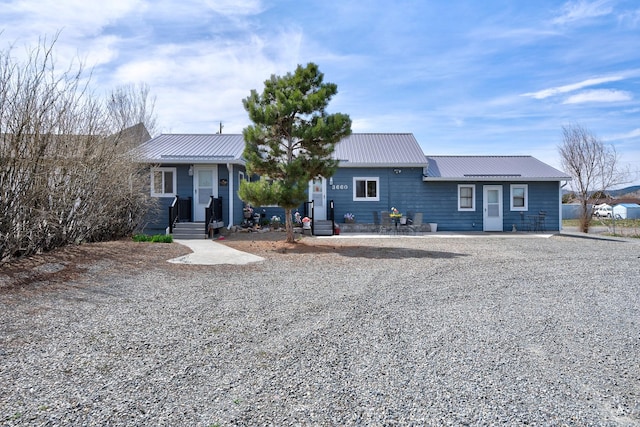 single story home featuring metal roof