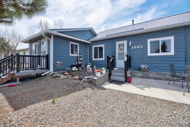 ranch-style house with a patio and metal roof
