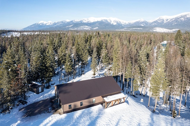 snowy aerial view with a mountain view