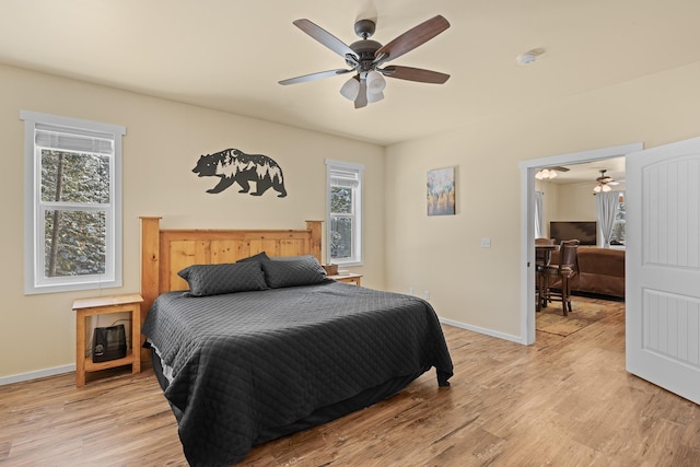 bedroom with ceiling fan and light hardwood / wood-style flooring