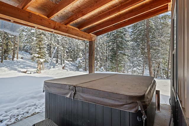 snow covered patio featuring a hot tub