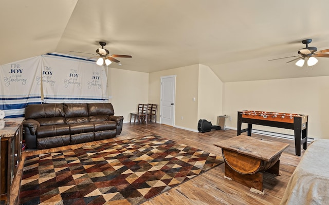 living room featuring hardwood / wood-style flooring, vaulted ceiling, and ceiling fan