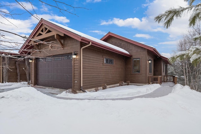 view of snow covered exterior with an attached garage