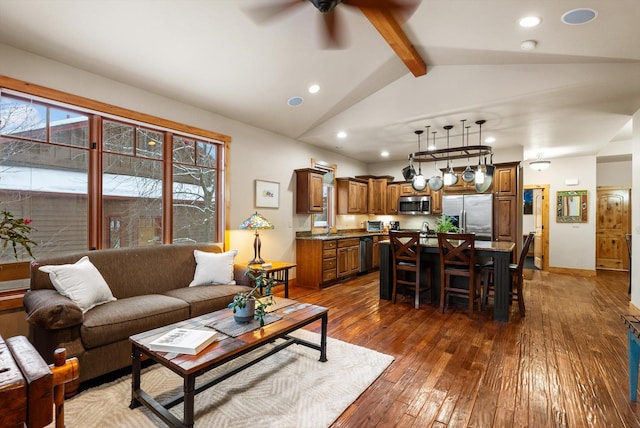 living room with vaulted ceiling with beams, recessed lighting, dark wood-type flooring, a ceiling fan, and baseboards