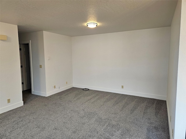 carpeted spare room featuring a textured ceiling