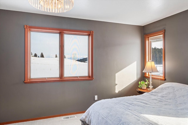 carpeted bedroom with baseboards and visible vents