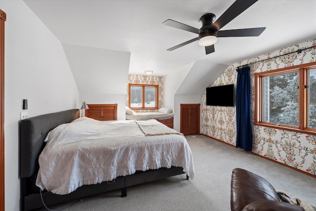 bedroom with carpet flooring, baseboards, ceiling fan, wallpapered walls, and lofted ceiling