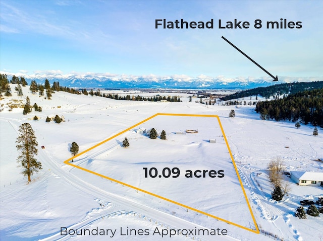 snowy aerial view featuring a mountain view