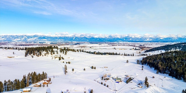 snowy aerial view with a mountain view