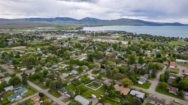 birds eye view of property with a water and mountain view