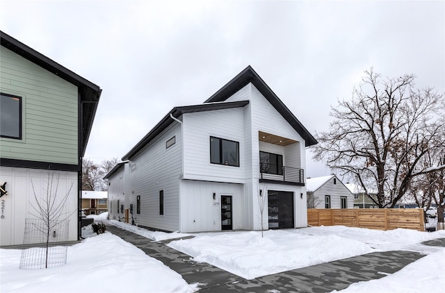 view of front facade with a balcony and a garage