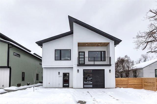 snow covered property with a garage