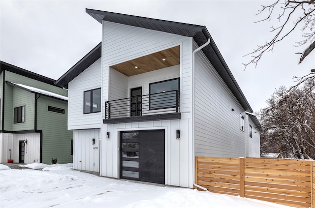 contemporary home with a balcony and a garage