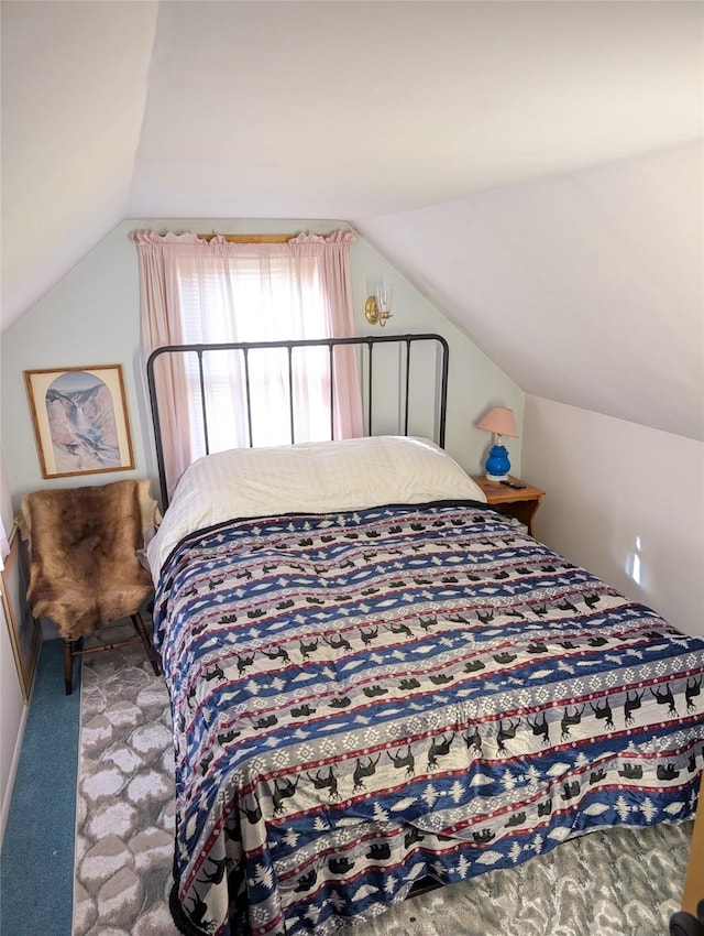 bedroom with vaulted ceiling and carpet