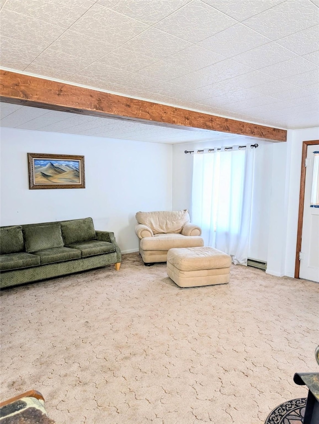 unfurnished living room featuring a baseboard heating unit, beamed ceiling, and carpet