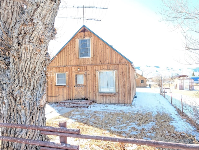 view of snow covered back of property