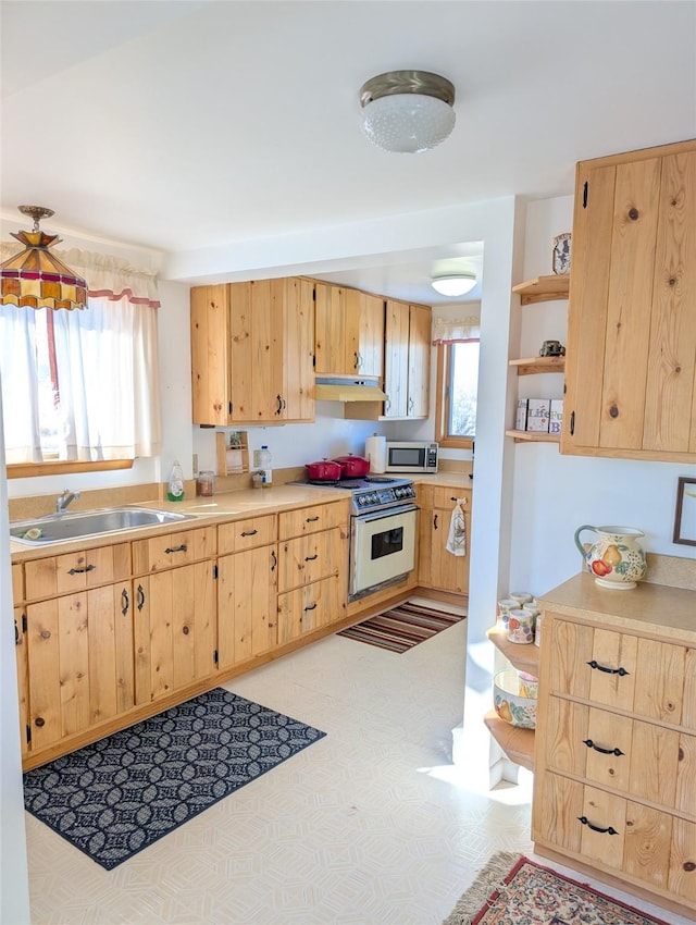 kitchen featuring sink, light brown cabinets, and electric range