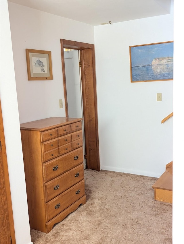 hallway with light colored carpet