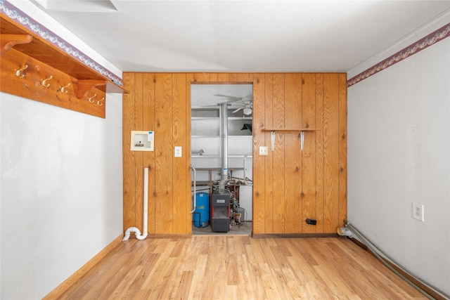 spare room with wood walls and light wood-style floors