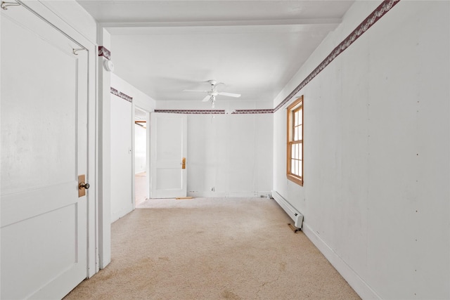 empty room with ceiling fan, baseboard heating, and light colored carpet