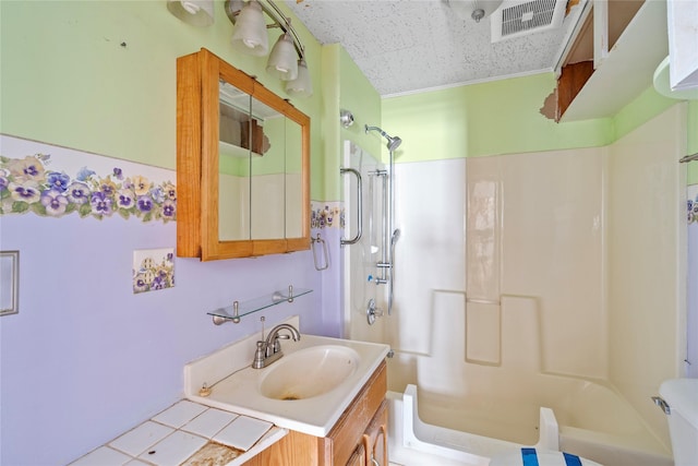 bathroom with washtub / shower combination, visible vents, and vanity