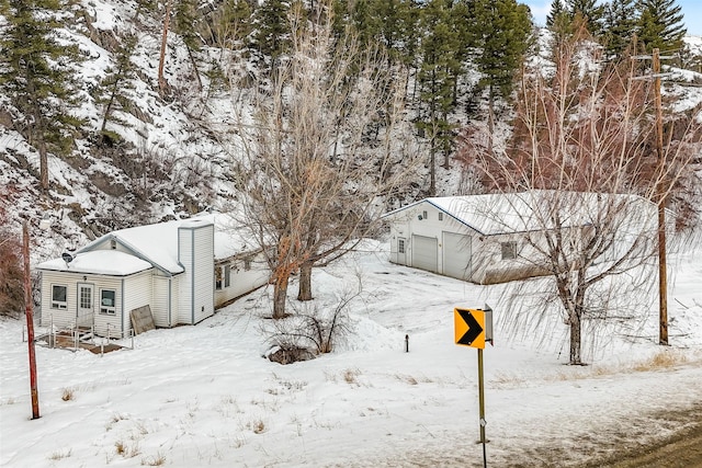 yard covered in snow with a detached garage