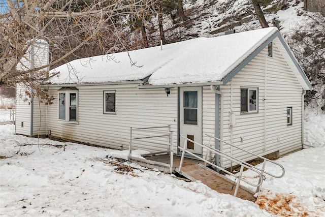 snow covered house with a garage