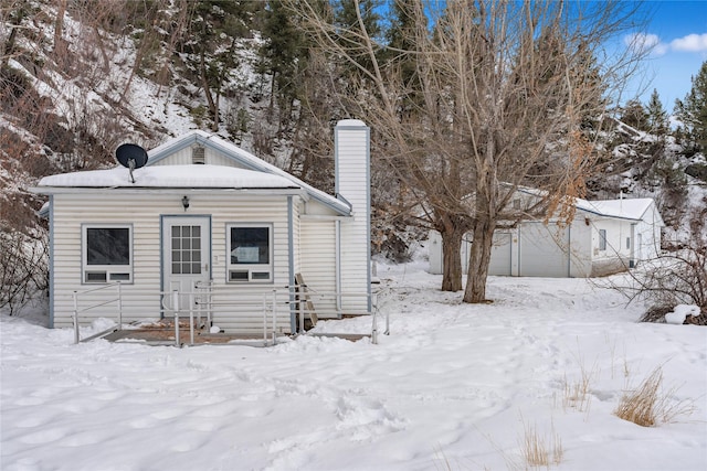 view of front of house featuring a garage and a chimney