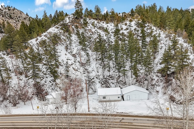 snowy aerial view with a mountain view