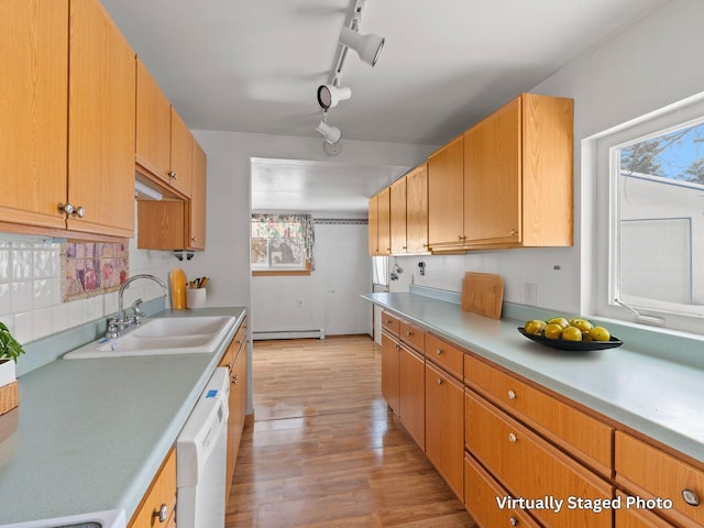 kitchen featuring decorative backsplash, light countertops, a sink, and dishwasher