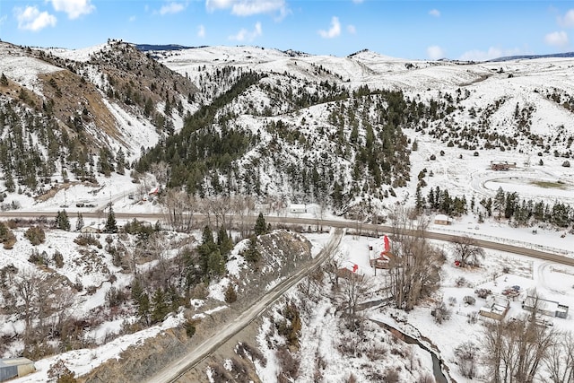 snowy aerial view with a mountain view