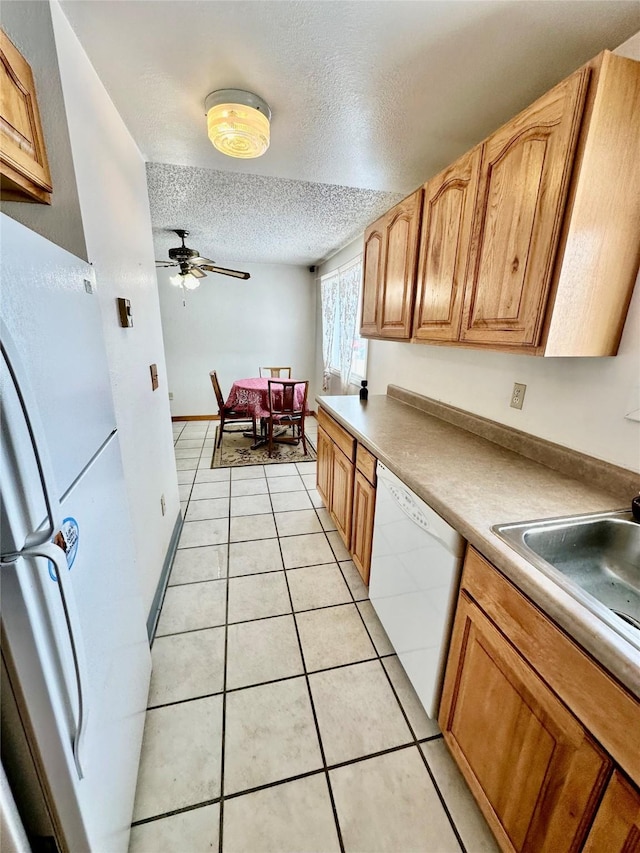 605 Idaho St, Deer Lodge, MT 59722 - kitchen featuring white appliances, a textured ceiling, light tile patterned flooring, ceiling fan, and light countertops