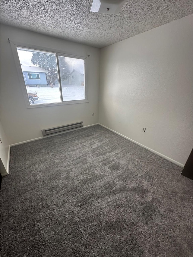 605 Idaho St, Deer Lodge, MT 59722 - empty room with a baseboard heating unit, carpet floors, a textured ceiling, and baseboards