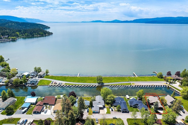 drone / aerial view featuring a water and mountain view