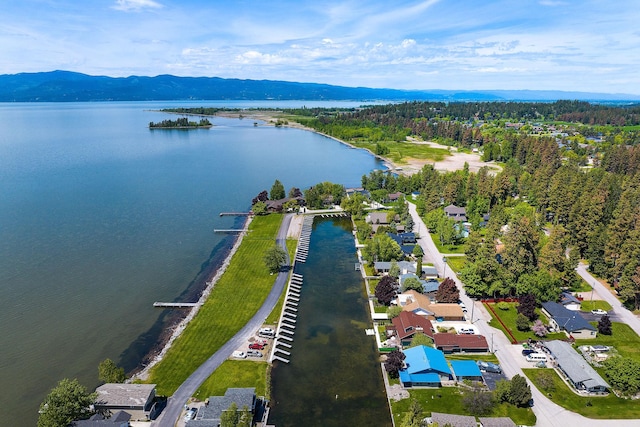 drone / aerial view featuring a water and mountain view