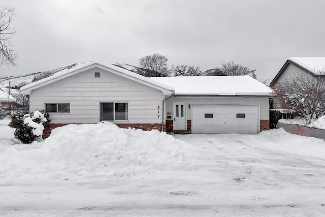 view of snow covered back of property